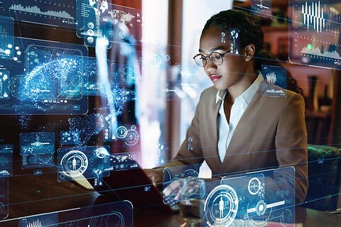 Frau sitzt am Computer, um sie herum schwebt eine grafische Oberfläche